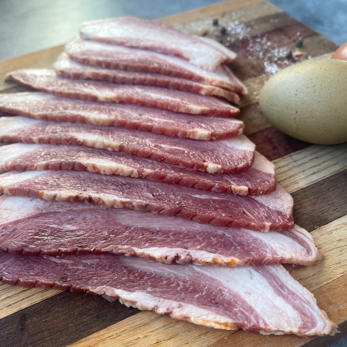 jowl bacon on a cutting board with colorful eggs