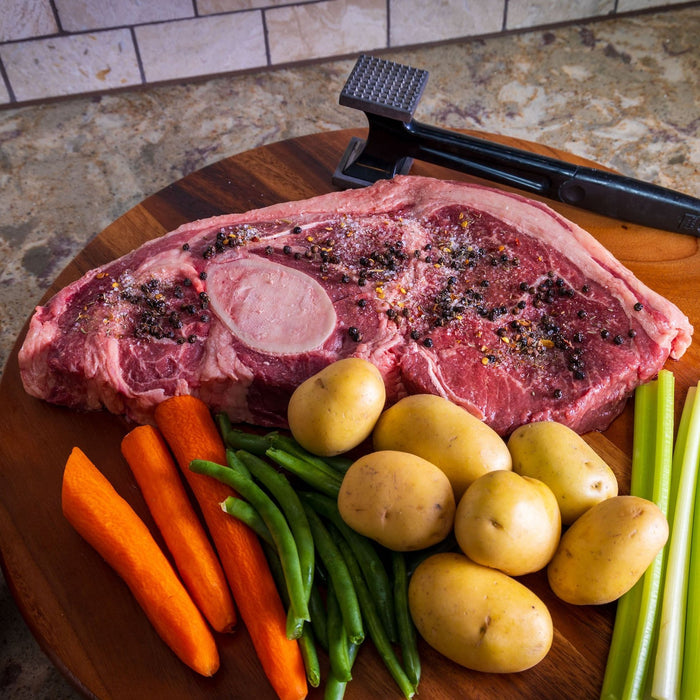 arm roast seasoned with salt and pepper with carrots, green beans, potatoes and celery