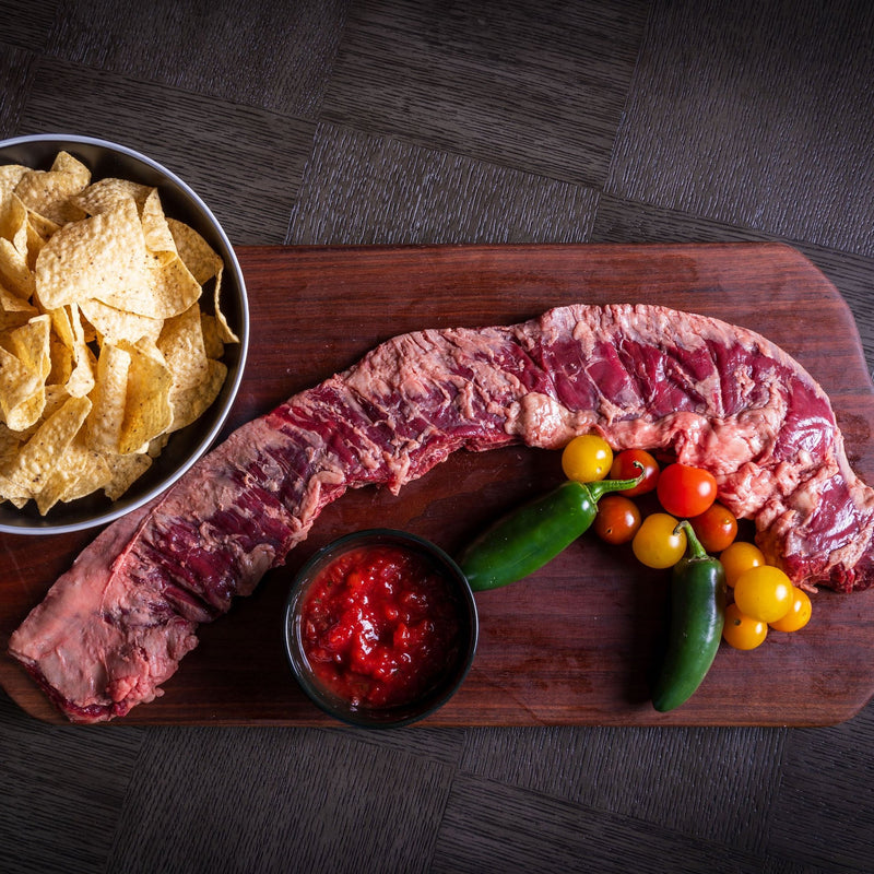 inside skirt steak with tortilla chips, salsa, cherry tomatoes and jalapeno